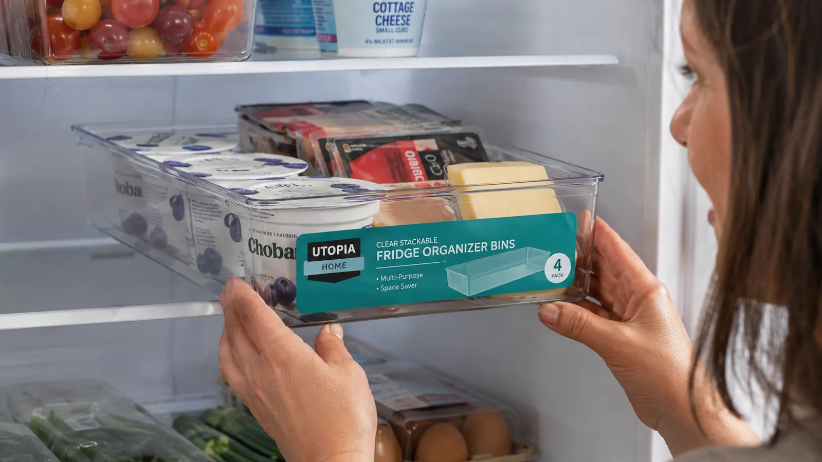 Clear Utopia Home fridge bins neatly holding yogurt containers, deli packages, and snack bags on a refrigerator shelf